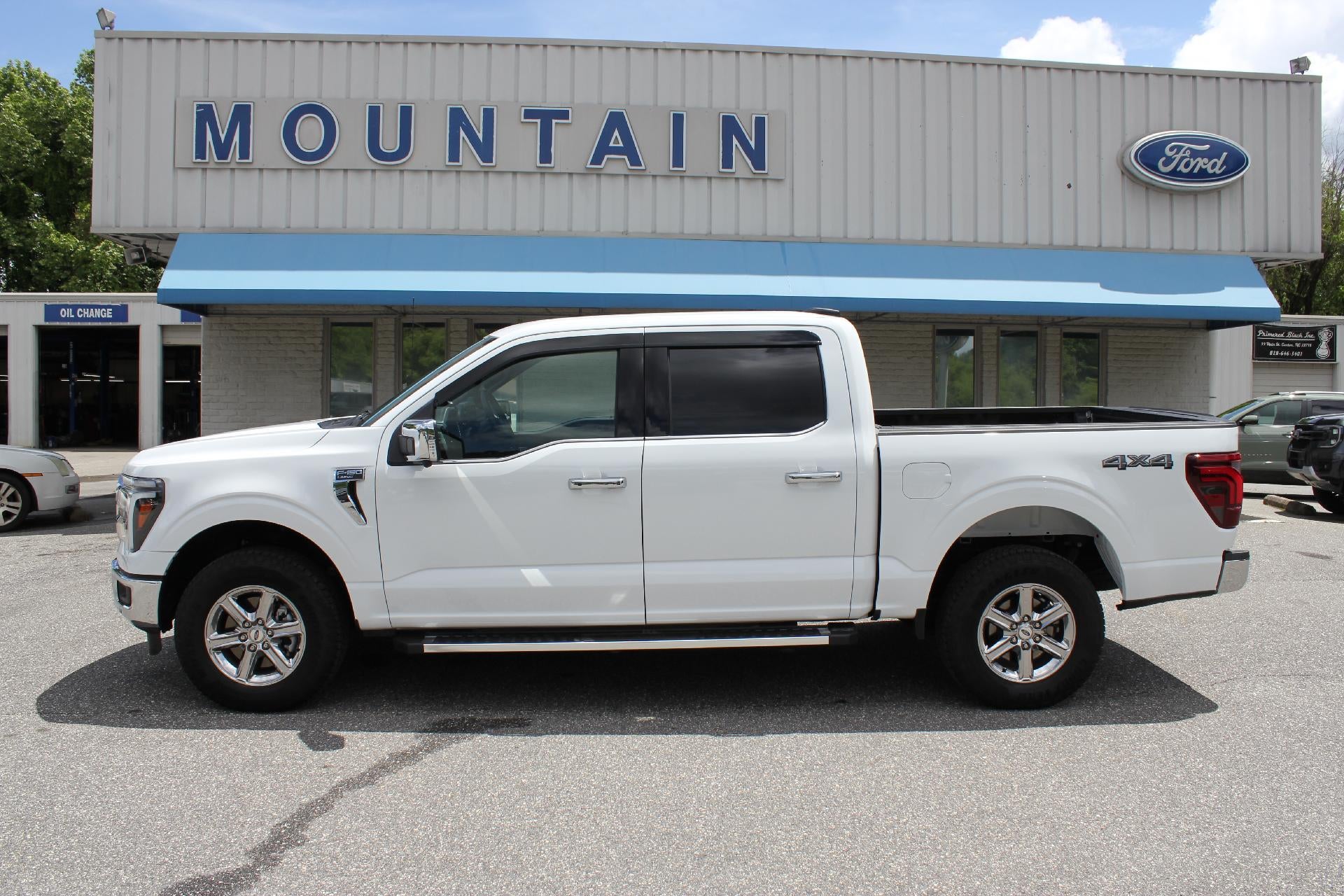 2025 Ford F-150 Lariat in White — front three-quarter view